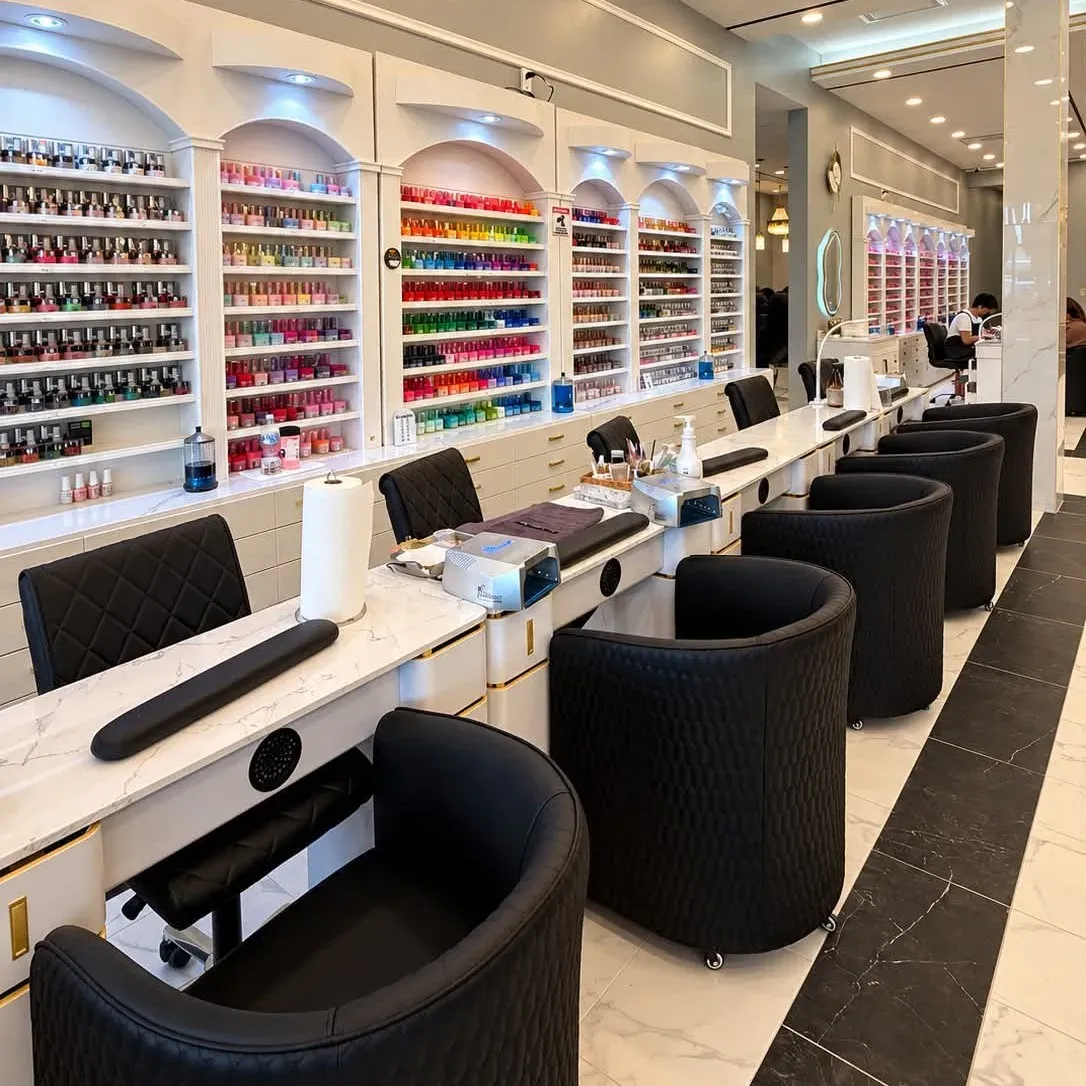 Row of manicure stations with polish wall at Xu Nails & Lashes